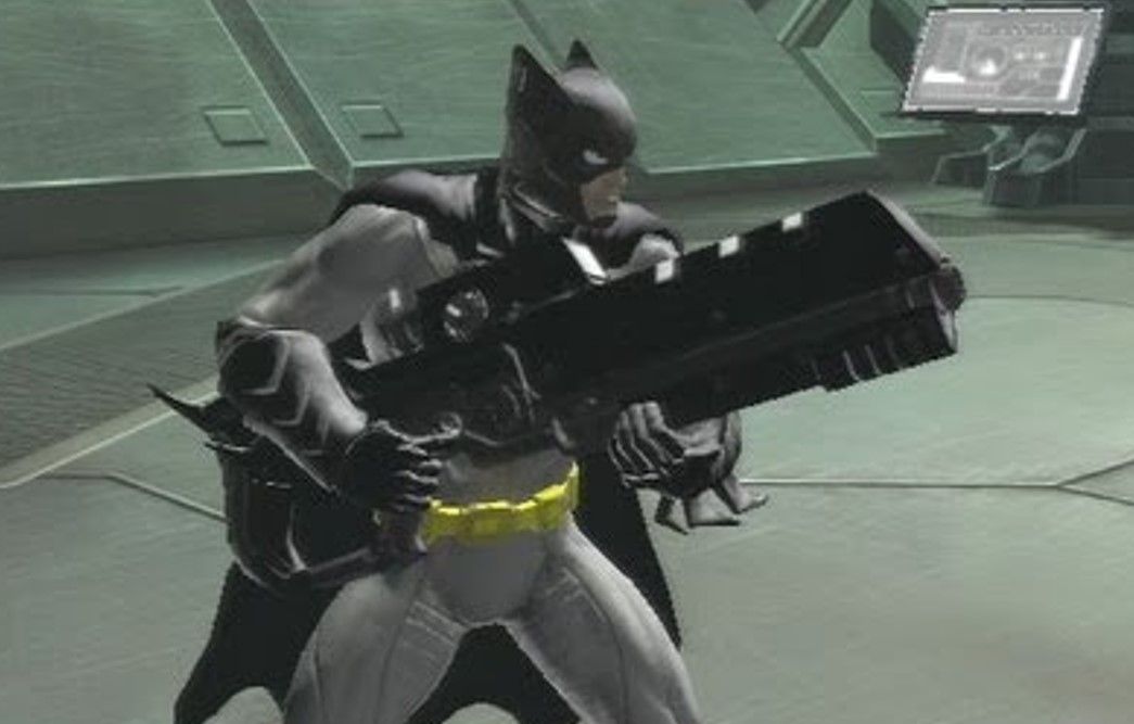 A Batman lookalike holds a rifle prepared to shoot