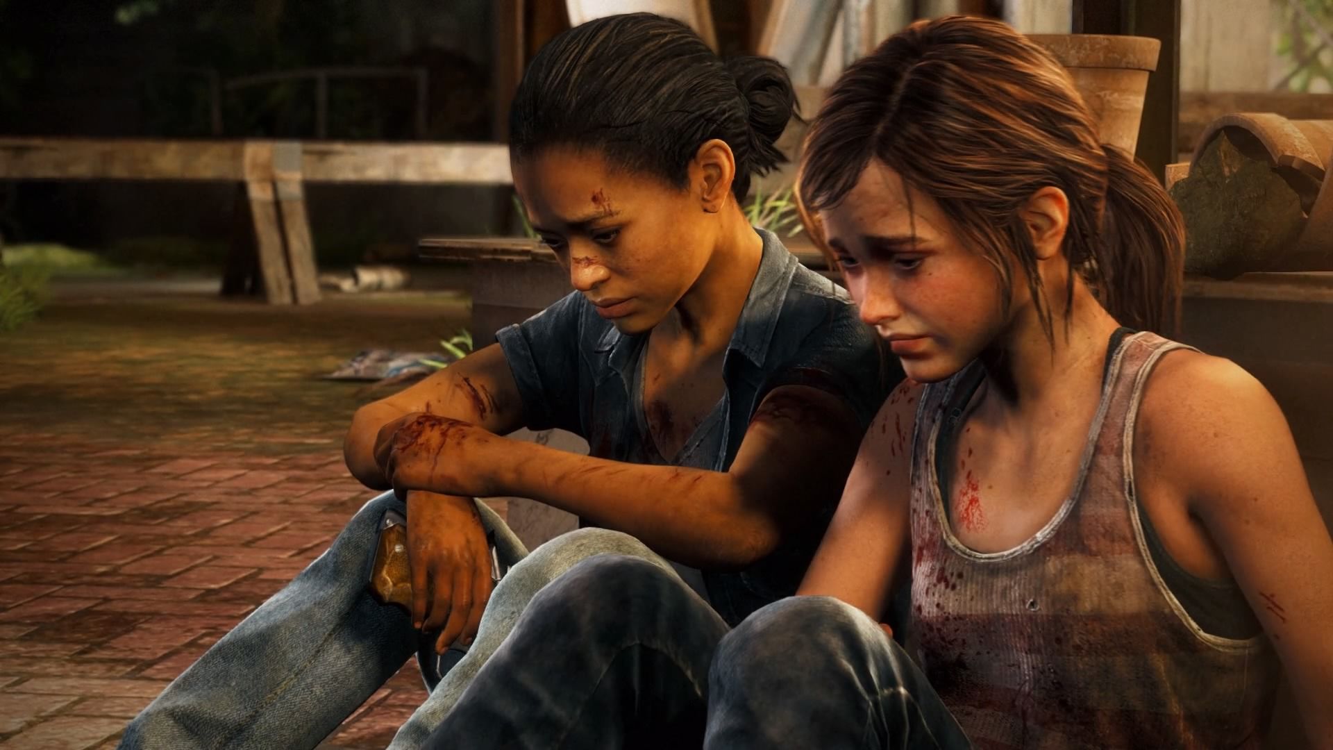 Ellie and Riley sit next to each other on the ground, both looking at the floor in front of them with worried expressions.