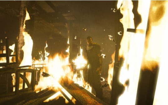 A screencapfrom the game "Outlast" where one of the characters is standing in the middle of a burning building.