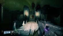 A Titan walks down a hallway on the moon, with the bodies of guardians looming above him.