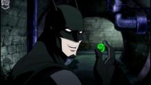 Batman playing around with Green Lantern's ring. Only true fans know what happened next.