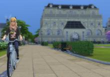 A sim riding a bicycle through the Sims 4 world of Britechester.