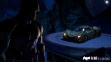 Batman looking at his Batmobile in Wayne Manor.