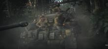 Soldiers ride on the outside and inside of tanks as they rumble through the jungle trail towards battle.
