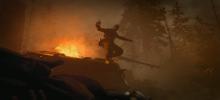 A soldier bails out of a tank at the last second as a large explosion goes off on the tanks side.
