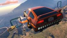 The Deluxo is flying through the sky in a race while going down the mountain.