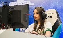 Pro gamer girl using headphones in a tournament.