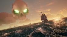 A green skull towers over the waters in Sea of Thieves.