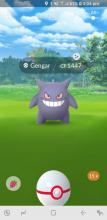 A trainer attempts to capture Gengar.