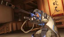 Ana takes aim with her rifle looking with her good eye