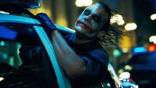 Joker escaping prison in a police car
