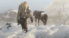 A player carries a deer carcass back to his horse.