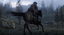 Arthur riding a dark-coated horse through the foggy highlands.