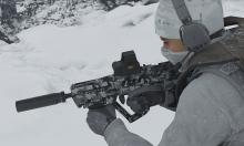 Artic soldier showing off his Tavor with a custom camo