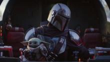 The Mandalorian holds Baby Yoda in his lap while flying, and it's really cute.