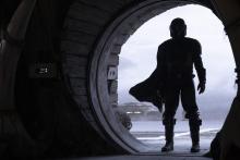 The first time we see Din, he's entering a cantina with his cape billowing dramatically behind him.