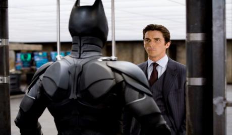 Bruce Wayne looking at Batsuit